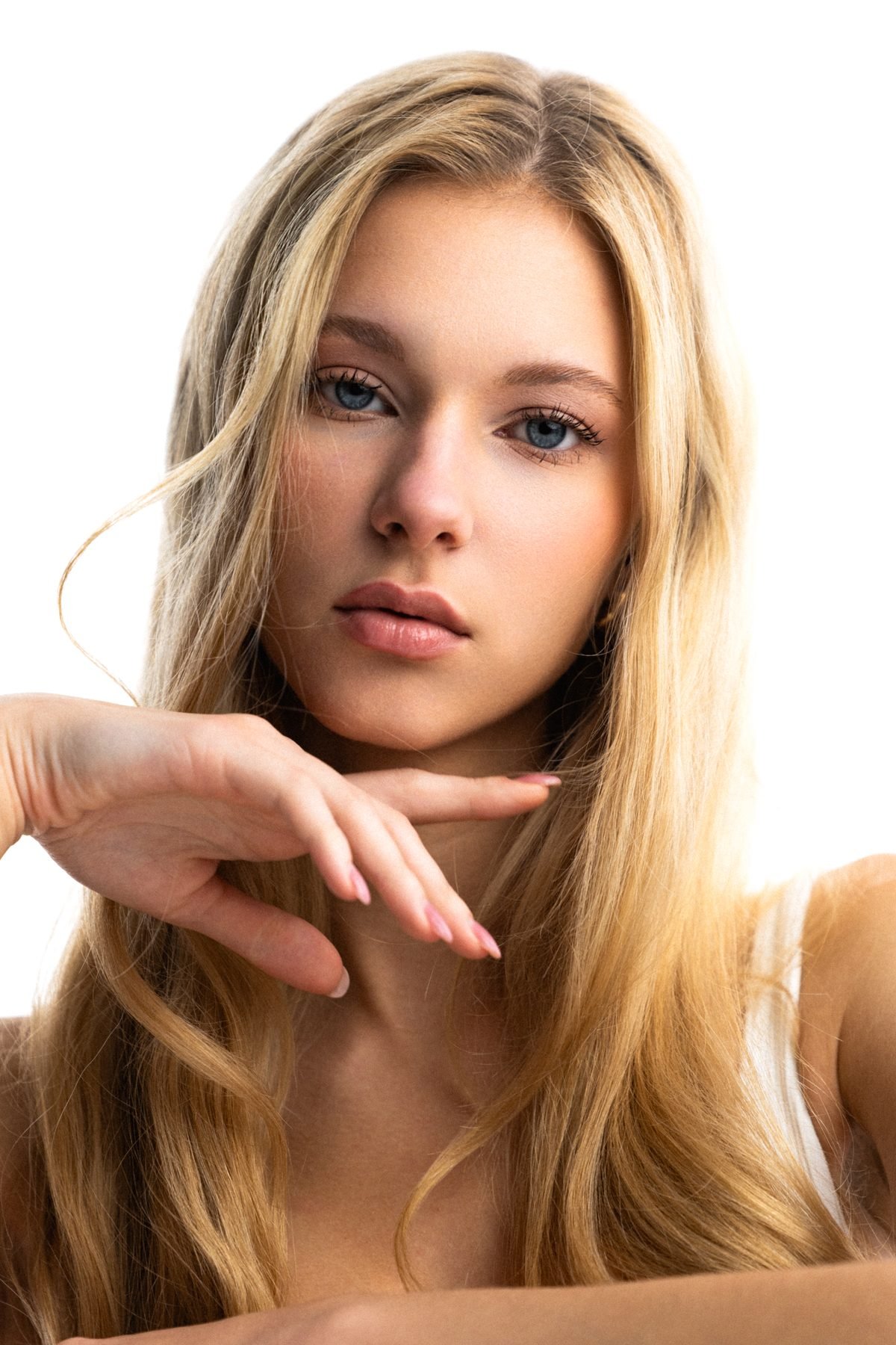 Beauty portrait of Veronika Syrovatka against a white studio backdrop